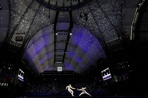Guillaume Bianchi competes with Kazuki Iimura in the men's team foil final match